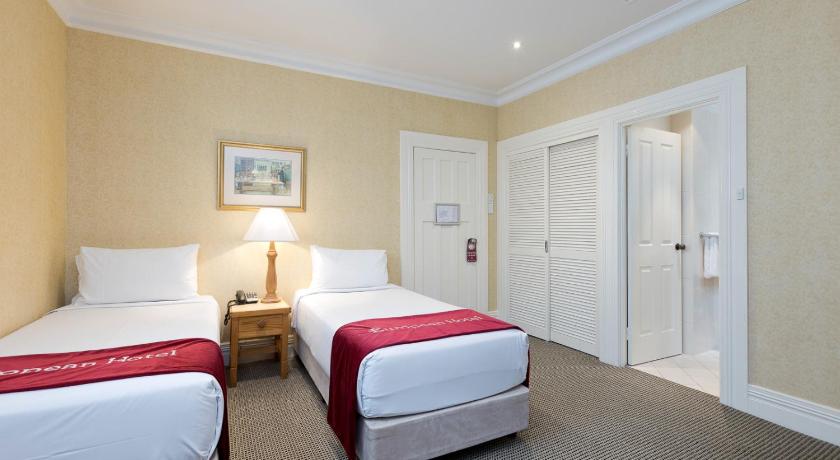 a hotel room with two beds and two lamps, European Hotel in Perth