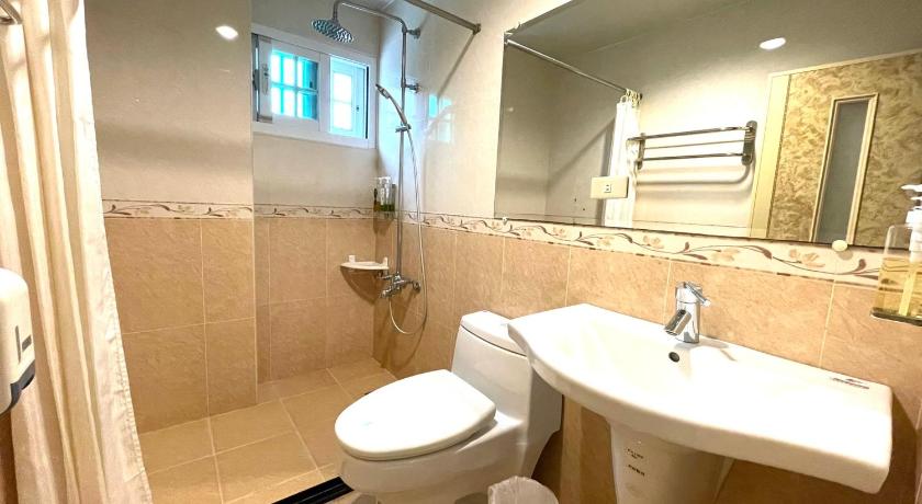 a white toilet sitting next to a sink in a bathroom, Shan Quan Zhi Lian Homestay in Yilan