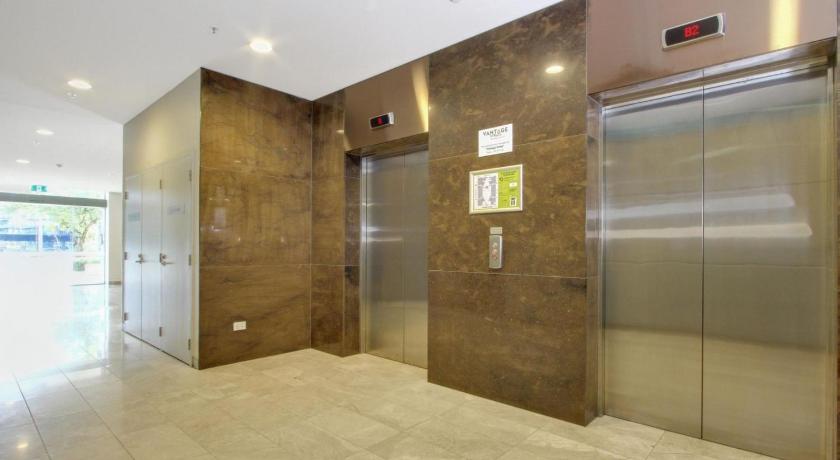 a bathroom with a large mirror and a walk in shower, Accommodate Canberra - IQ Smart Apartments in Canberra