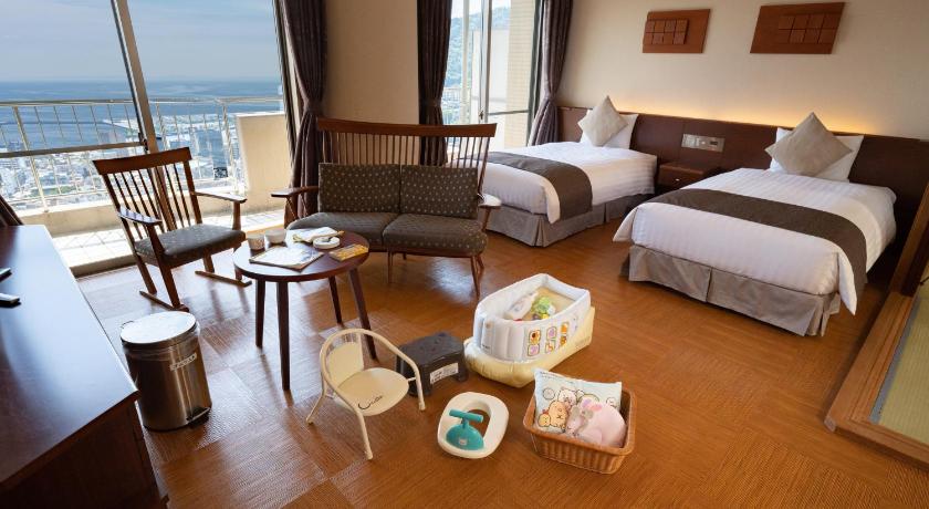 a hotel room with a bed, table and chairs, KAMENOI HOTEL ATAMI in Atami