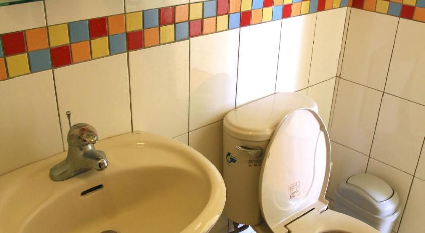 a white toilet sitting next to a sink in a bathroom, WonderOcean Dive Hostel in Kenting
