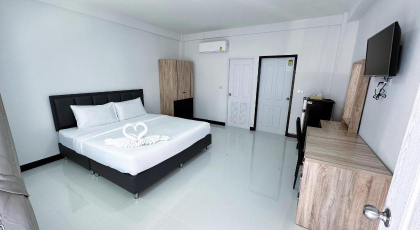 a bedroom with a bed and a desk, The Wisdom Residence in Bueng Kan
