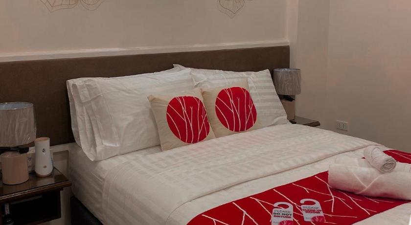 a bed with a white blanket and pillows on it, KHOTEL  in Manila