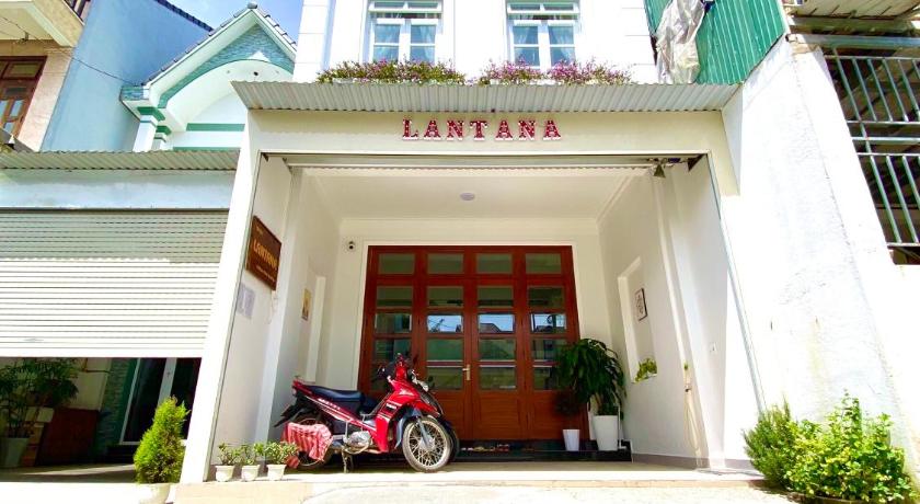a white car parked in front of a building, Lantana Homestay in Dalat