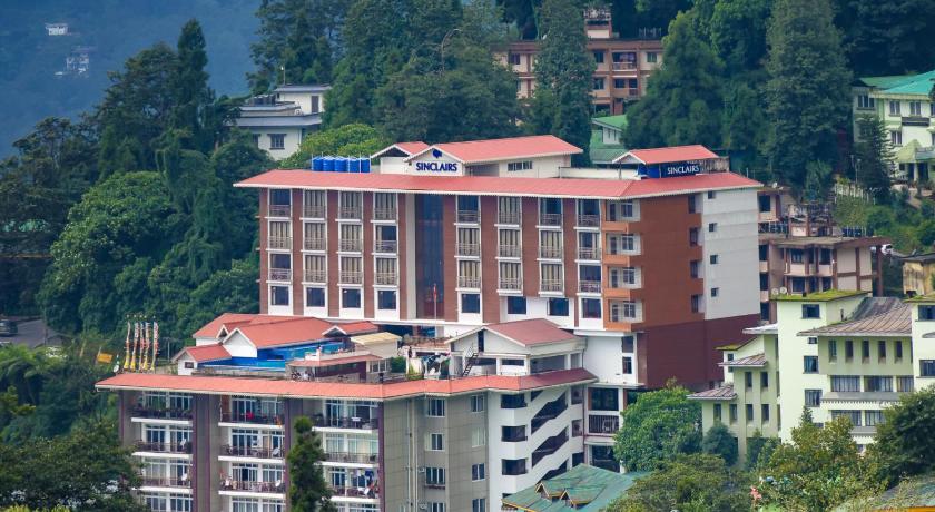 a large building with a clock on the side of it, Sinclairs Gangtok in Gangtok