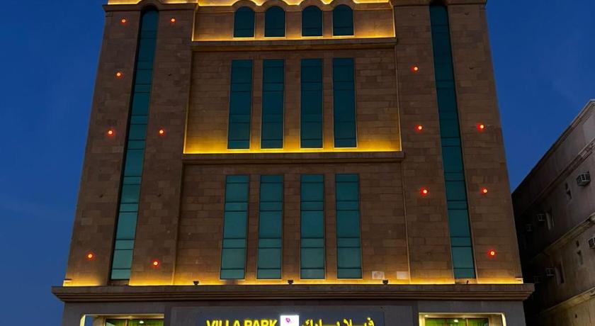 a large building with a clock on the front of it, Villa Park in Al-Khobar