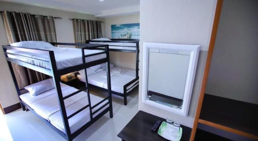 a bedroom with two bunk beds and a desk, Marco’s Tourist Inn in Ormoc
