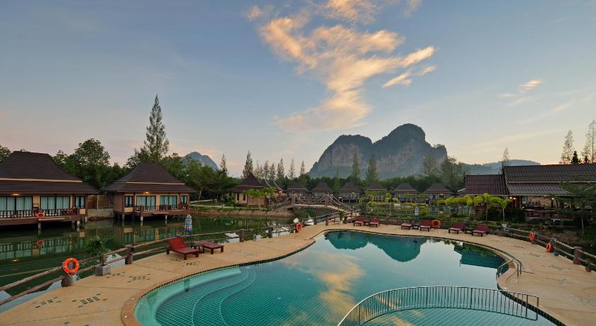 a large swimming pool in front of a large building, Poonsiri Resort Aonang (SHA Plus+) in Krabi