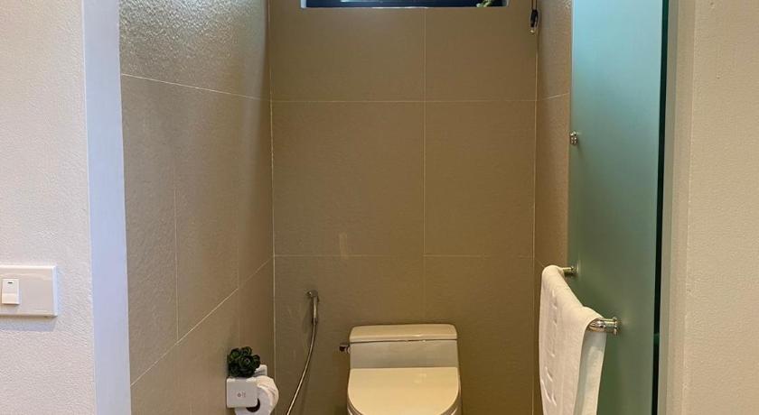 a small bathroom with a toilet and a sink, River Kwai Kiri Resort in Kanchanaburi