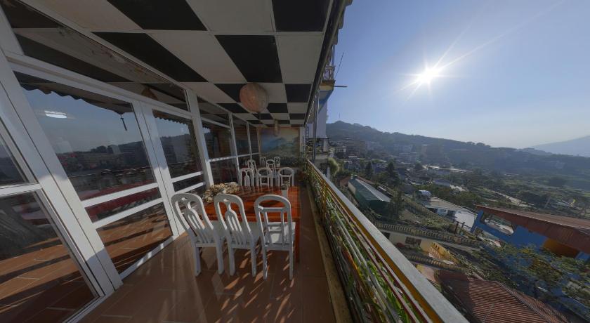 a view from a balcony of a balcony overlooking a city, Cat Cat Sunrise Hotel in Sapa