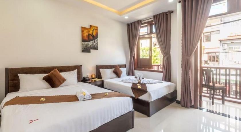 a bedroom with two beds and a window, Miss Ten Homestay in Hoi An