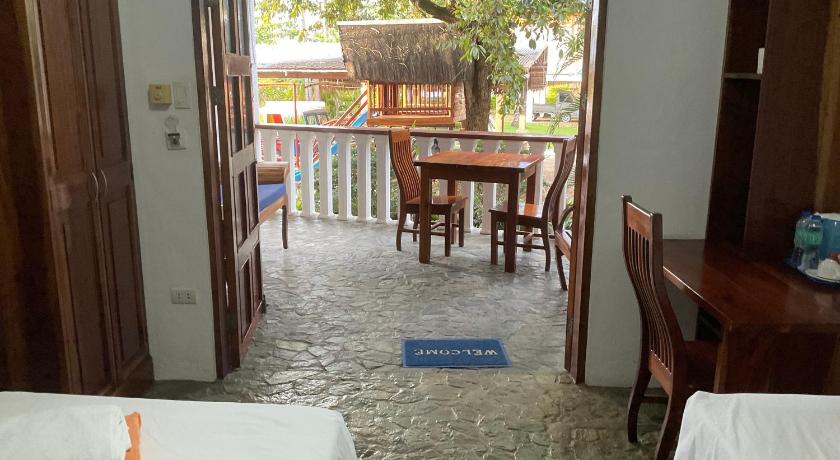 a room with a table, chairs and a door, Rainbow Bay Beach & Dive Resort in Siquijor Island