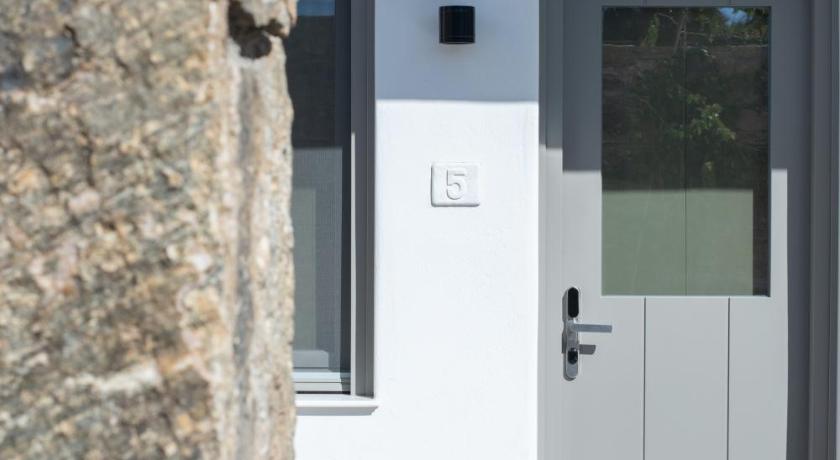 a door to a building with a white door, Fabrikas in Mykonos