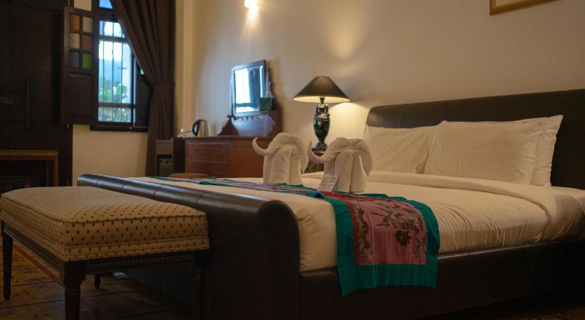 a hotel room with a bed, chair, and nightstand, Areca Hotel Penang in Penang