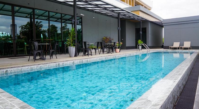 a swimming pool with a pool table and chairs, Hotel Scarlett in Nakhon Si Thammarat