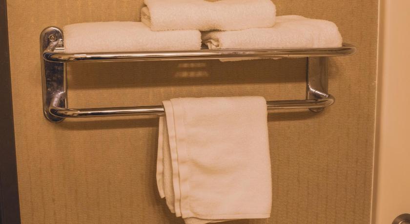 a white towel hanging on the side of a white towel rack, Colfax Inn by Marifah - Adults Only in Colfax (IA)