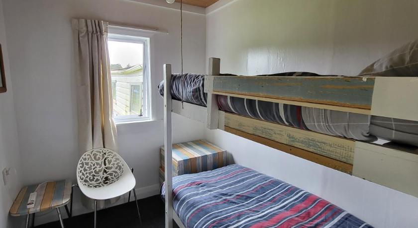 a bedroom with a bed and a window, National Park Alpine Lodge in Tongariro National Park