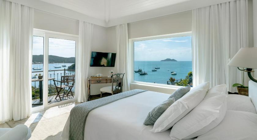 a hotel room with a view of the ocean, Abracadabra Pousada in Buzios