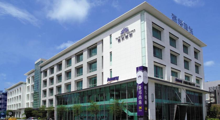a large building with a clock on the front of it, Taipung Suites Hotel in Tainan