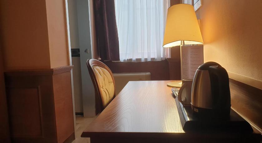 a room with a table and chairs and a lamp, Le Club Boutique Hotel in Lecce