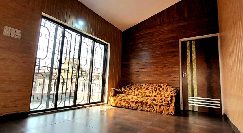 a room with a wooden floor and a large window, Destiny Villa in Lonavala