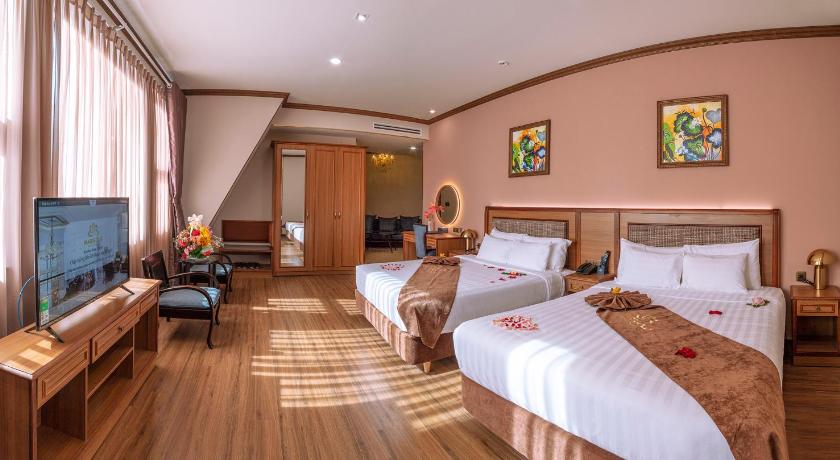 a hotel room with two beds and a television, MARIGOLD HOTEL DALAT in Dalat