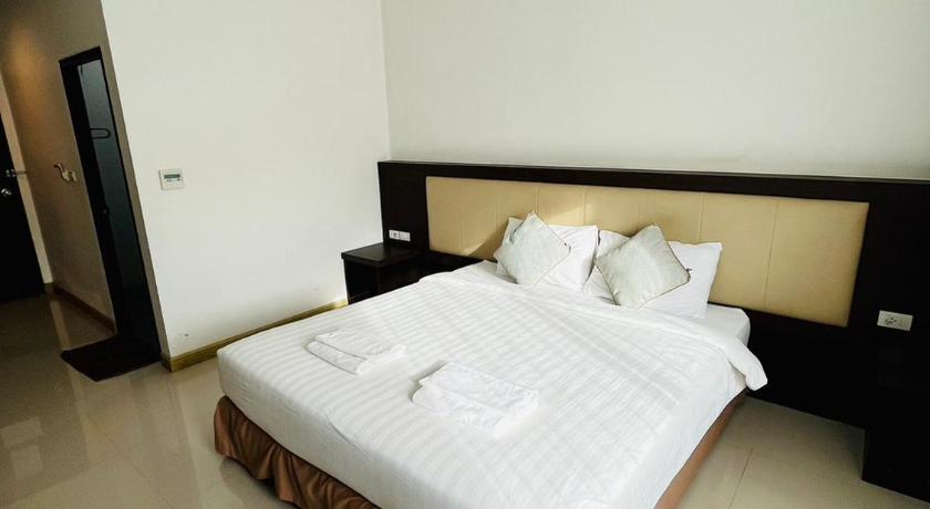 a hotel room with a white bed and white walls, Bualinn Resort in Nong Khai
