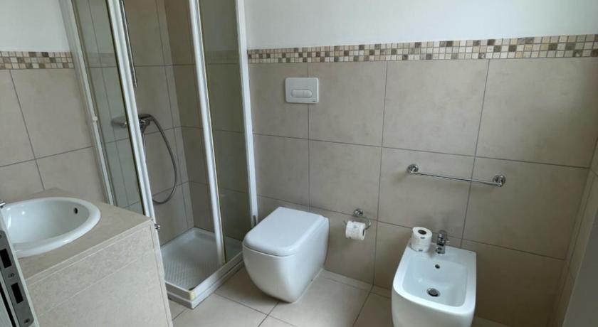a bathroom with a toilet, sink, and shower, 19 CondoHotel in Santa Cesarea Terme