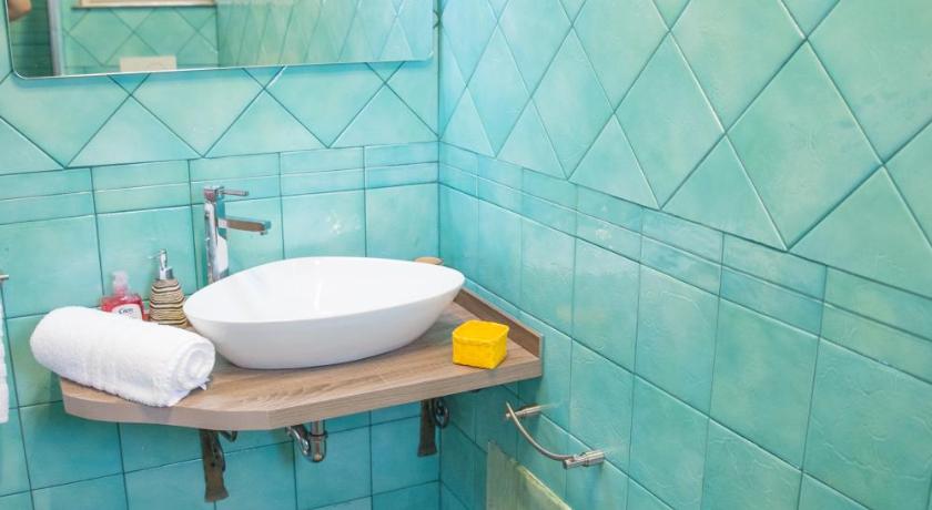 a bathroom with a sink, toilet and tub, Acqua Azzurra in Alghero
