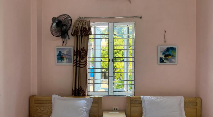 a bedroom with a bed and a window, Cat Ba Sweet Potato in Cat Ba Island