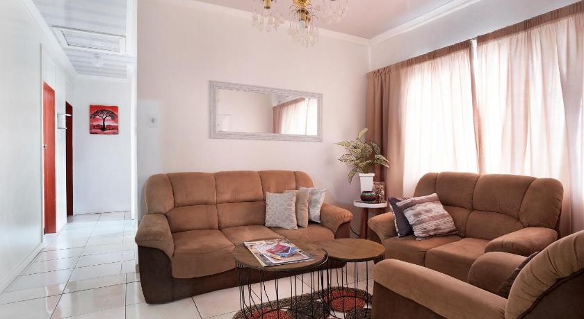 a living room filled with furniture and a couch, 25 Jacaranda Lodge & Backpackers in Durban