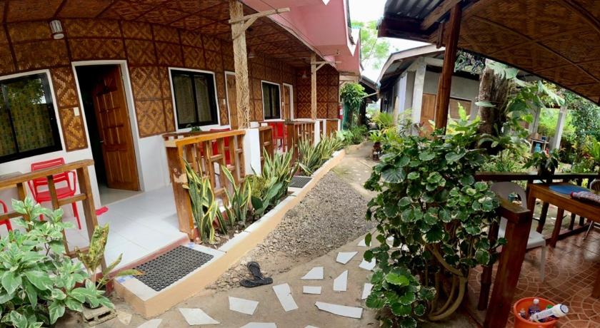 a patio area with a patio table and chairs, Domos Native Guest House in Bohol