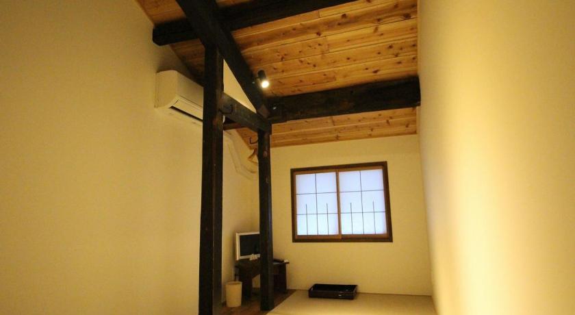 a room with a bed and a window, Mihokan in Matsue