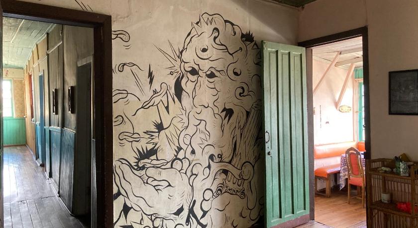 a room with a painting on the wall and graffiti on the walls, Hostal brons in Valparaiso