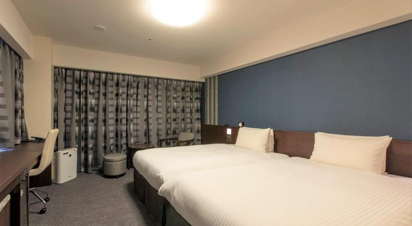 a hotel room with a bed and a television, Richmond Hotel Fukuoka Tenjin in Fukuoka