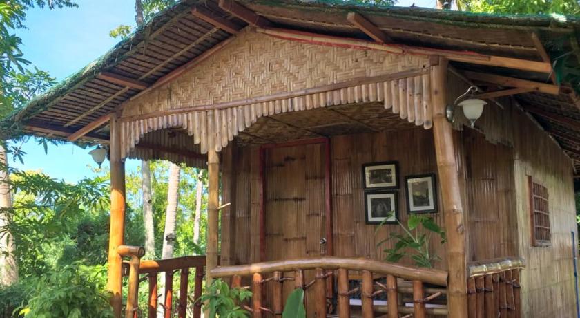 a house that has a wooden fence around it, Casa de Corazon Native House For Rent in Bohol