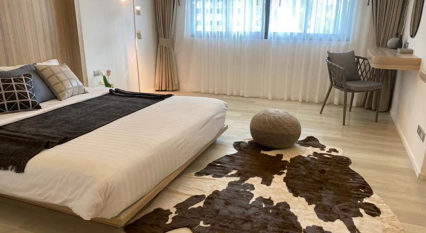 a room with a bed, a chair, and a painting on the wall, S2 Hotel (SHA Extra Plus) in Chonburi