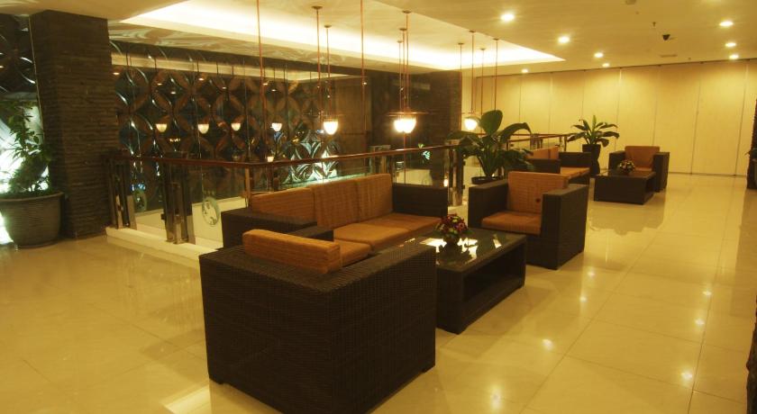 a living room filled with lots of furniture, Hotel Arjuna Yogyakarta in Yogyakarta