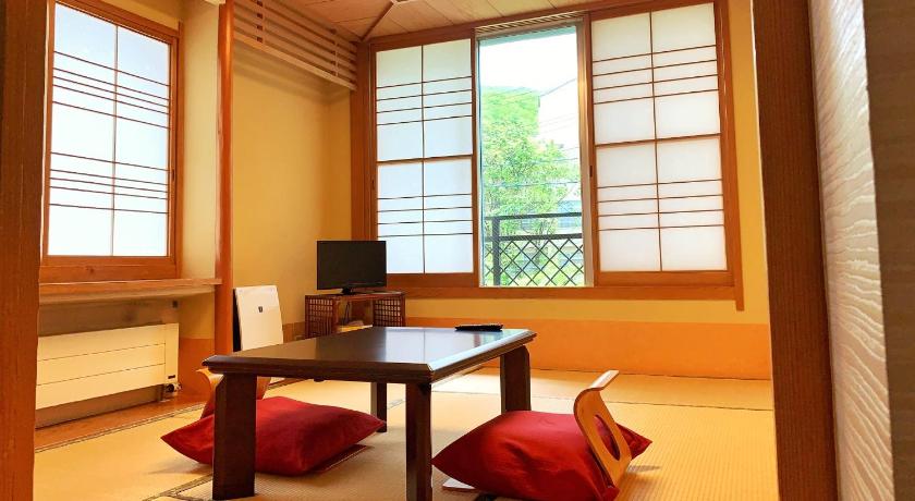 a living room filled with furniture and a window, Pension Puutaro in Yamagata