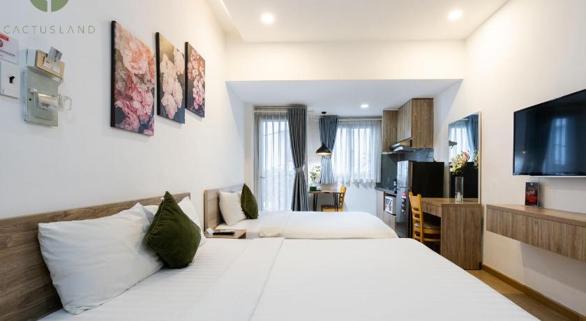a hotel room with a large bed and a large window, Cactusland Apartment in Ho Chi Minh City