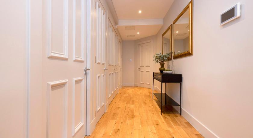 a living room with a wooden floor and white walls, ALTIDO Luxury 2BR home on George Street in Edinburgh