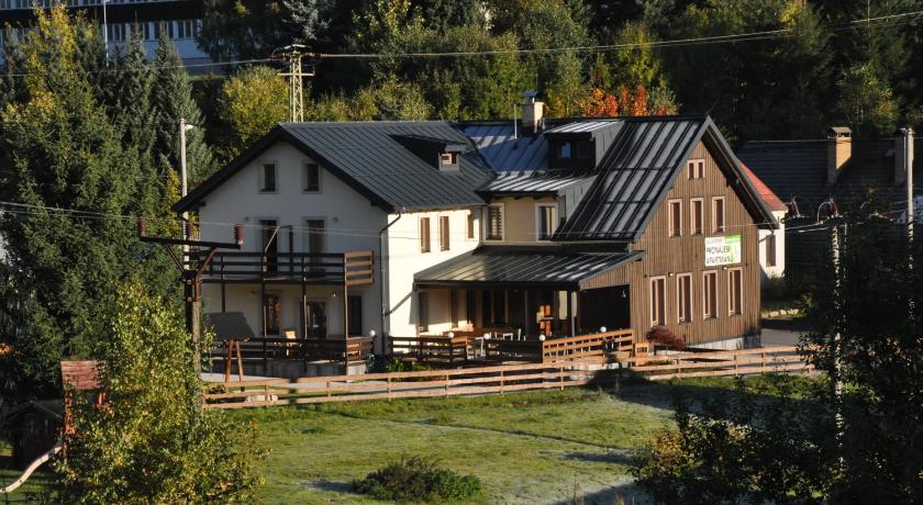 a house with a wooden roof and a white house, Chata Vermont in Bedrichov U Jablonce Nad Nisou