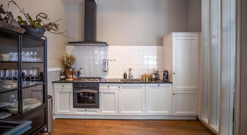 a kitchen with a stove, sink and cabinets, Royal 2 Bedroom City House Grande Madame Agaath in Leeuwarden
