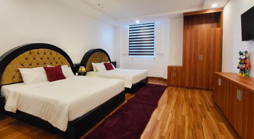 a bedroom with a bed and a dresser, Hoang Son Hotel in Cần Thơ