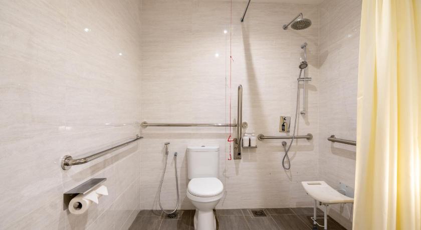 a bathroom with a toilet a sink and a bath tub, Holiday Inn Express And Suites Johor Bahru in Johor Bahru