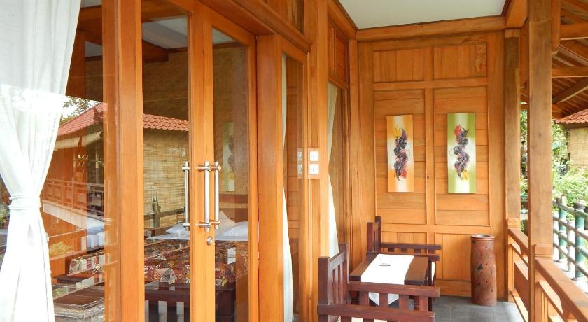 a room with a wooden floor and a wooden ceiling, Villa Dua Bintang in Bali