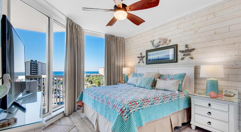 a bedroom with a large bed and a large window, St. Lucia 802 by RealJoy Vacations in Destin (FL)