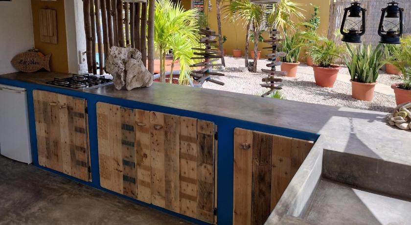 a kitchen with wooden cabinets and wooden floors, Barefoot Bonaire in Kralendijk