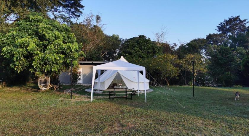 a white tent sitting on top of a grass covered field, StayKtion in Chiang Rai