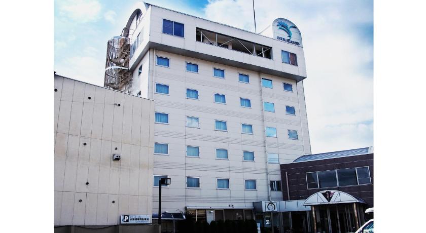 a large white building with a large clock on it, Takayama City Hotel Four Seasons in Takayama
